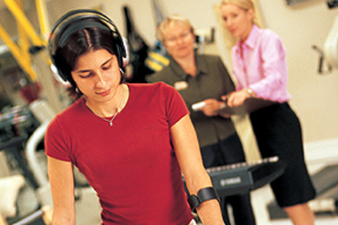 SCI Research in Action featuring a woman in a red shirt wearing headphones